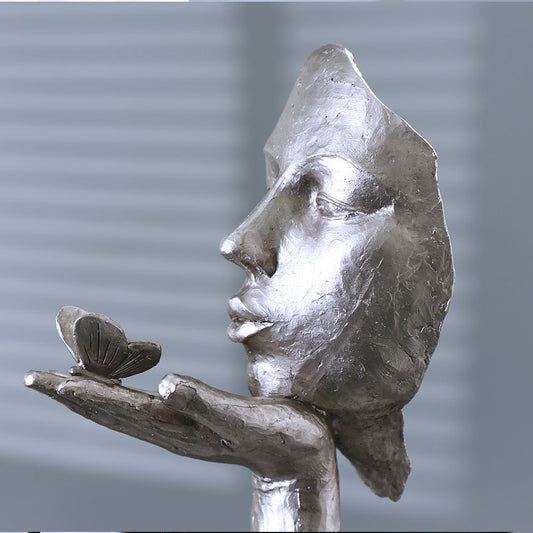 Face and Butterfly Sculpture