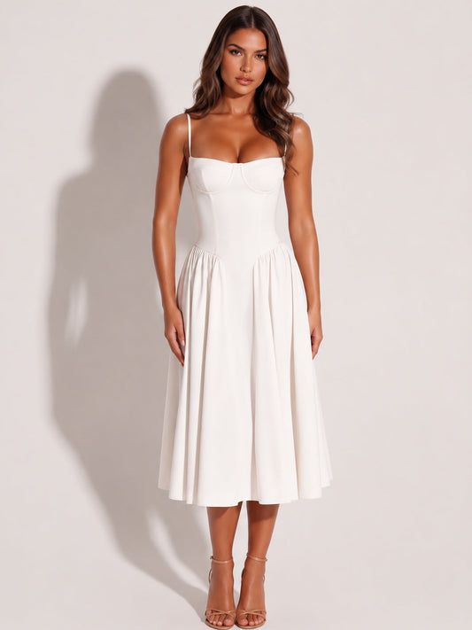Model wearing a white cotton midi dress with a fitted bodice and full skirt
